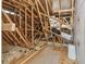 Unfinished attic space with exposed beams, insulation, and a plywood flooring section at 3530 Brook Crossing Dr, Brandon, FL 33511