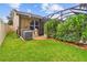 Landscaped backyard with healthy green lawn leads to a screened in pool area at 3530 Brook Crossing Dr, Brandon, FL 33511