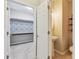 Half bathroom featuring decorative tile accents, modern fixtures, and adjacent storage or laundry area at 3530 Brook Crossing Dr, Brandon, FL 33511