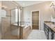Bathroom featuring a glass-enclosed shower, soaking tub, granite counters, and a walk-in closet at 3530 Brook Crossing Dr, Brandon, FL 33511