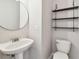 Modern bathroom featuring a pedestal sink, open shelving, and toilet at 3530 Brook Crossing Dr, Brandon, FL 33511