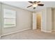 Bedroom features a ceiling fan, a window with blinds, and a closet at 3530 Brook Crossing Dr, Brandon, FL 33511