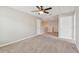 Large bedroom with neutral carpet, ceiling fan and two doors at 3530 Brook Crossing Dr, Brandon, FL 33511