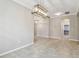 Dining area with tile flooring, modern lighting, and an archway leading to another room at 3530 Brook Crossing Dr, Brandon, FL 33511