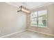Dining area featuring tile flooring, natural light from the window, and a modern light fixture at 3530 Brook Crossing Dr, Brandon, FL 33511