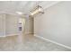 Dining room with tile flooring, modern light fixture, and arched entryways at 3530 Brook Crossing Dr, Brandon, FL 33511
