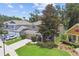 Aerial view of a two-story home with a well-manicured lawn, mature trees, and neutral colored exterior at 3530 Brook Crossing Dr, Brandon, FL 33511