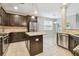 Well-equipped kitchen featuring dark cabinets, granite counters, stainless appliances, and a functional center island at 3530 Brook Crossing Dr, Brandon, FL 33511