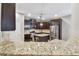 Kitchen featuring dark cabinetry, granite countertops, stainless steel appliances, and a central island at 3530 Brook Crossing Dr, Brandon, FL 33511