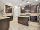 Stylish kitchen with dark cabinetry, granite countertops, a center island, stainless appliances and recessed lighting at 3530 Brook Crossing Dr, Brandon, FL 33511
