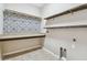 Laundry room with granite countertops and decorative backsplash for functionality and style at 3530 Brook Crossing Dr, Brandon, FL 33511