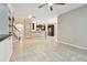 Open-concept living room with tile flooring leading to the staircase and the kitchen in the background at 3530 Brook Crossing Dr, Brandon, FL 33511