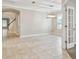 Open living room with neutral tile flooring and modern lighting at 3530 Brook Crossing Dr, Brandon, FL 33511