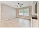 Bright living room featuring tile flooring, a ceiling fan, and lots of natural light from the window at 3530 Brook Crossing Dr, Brandon, FL 33511