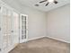 Bright office space featuring ceiling fan and French doors leading to main living area at 3530 Brook Crossing Dr, Brandon, FL 33511