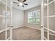 Office space with carpet, ceiling fan, and French doors, offering a private workspace at 3530 Brook Crossing Dr, Brandon, FL 33511