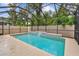 Backyard with a pool, lawn, and plantings. The pool area has a screened enclosure at 3530 Brook Crossing Dr, Brandon, FL 33511