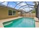 Screened pool with waterfall feature and exterior lighting at 3530 Brook Crossing Dr, Brandon, FL 33511