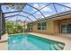 Backyard pool with a screened enclosure, and the patio and home are beige and brown at 3530 Brook Crossing Dr, Brandon, FL 33511
