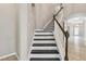 Staircase with dark treads and a white banister at 3530 Brook Crossing Dr, Brandon, FL 33511