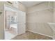 Walk-in closet entrance featuring wire shelving, connecting to the main bath with shower and tub at 3530 Brook Crossing Dr, Brandon, FL 33511