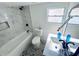 Modern bathroom featuring a marble tile surround bathtub and black fixtures complementing the patterned floor at 368 6Th Nw St, Largo, FL 33770