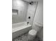 Modern bathroom featuring a marble tiled shower and black hardware paired with decorative patterned flooring at 368 6Th Nw St, Largo, FL 33770