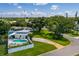 Beautiful home with an in-ground pool, lush landscaping, and mature trees on a sunny day at 3700 56Th N St, St Petersburg, FL 33710