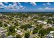 A high-angle view showcases a neighborhood with a particular home featuring a pool and backyard emphasized by a white circle at 3700 56Th N St, St Petersburg, FL 33710