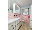 Traditional bathroom featuring pink tile, window and vanity at 3700 56Th N St, St Petersburg, FL 33710