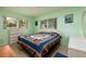 Relaxing bedroom with a comfortable bed, natural light, and calm green walls at 3700 56Th N St, St Petersburg, FL 33710