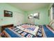 Bright bedroom featuring a quaint window and quilt bedspread at 3700 56Th N St, St Petersburg, FL 33710