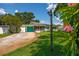 A well-maintained home featuring a lush green lawn, screen enclosed patio, and a bright blue garage door at 3700 56Th N St, St Petersburg, FL 33710