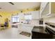 Well-lit kitchen with white cabinets, stainless appliances, and a view into the adjacent space at 3700 56Th N St, St Petersburg, FL 33710