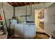Laundry room with washer, dryer, water heater and blue storage room at 3700 56Th N St, St Petersburg, FL 33710