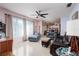 Spacious living room with comfortable seating, a ceiling fan, and large windows at 3700 56Th N St, St Petersburg, FL 33710