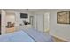 This bedroom features a TV, a dresser, and access to an additional living space at 3836 N Lake Dr # 121, Tampa, FL 33614
