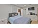 Comfortable bedroom with a tufted headboard, soft bedding, and a dresser, creating a relaxing retreat at 3836 N Lake Dr # 121, Tampa, FL 33614