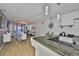 Modern kitchen with breakfast bar opening to a living area with modern decor, dining space, and natural light at 3836 N Lake Dr # 121, Tampa, FL 33614