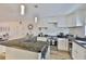 Updated kitchen with granite countertops, white cabinetry, stainless steel appliances, and a breakfast bar area at 3836 N Lake Dr # 121, Tampa, FL 33614