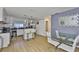 Modern kitchen with white cabinets, granite countertops, stainless steel appliances, and an adjacent dining area at 3836 N Lake Dr # 121, Tampa, FL 33614