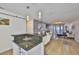 Open-concept kitchen flowing into the living room, featuring a breakfast bar, dining area, and modern decor at 3836 N Lake Dr # 121, Tampa, FL 33614