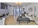 Inviting living room with neutral tones, a sliding glass door to the balcony, and comfortable seating arrangements at 3836 N Lake Dr # 121, Tampa, FL 33614