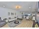 Bright living room with contemporary decor, including a white sofa, glass coffee table, and open layout to the kitchen at 3836 N Lake Dr # 121, Tampa, FL 33614
