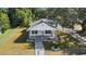 A stunning aerial view of the home showcasing the landscaping, fence, and surrounding trees at 4112 E Ellicott St, Tampa, FL 33610