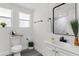 Bright bathroom features a modern vanity, black hardware, and a framed mirror at 4112 E Ellicott St, Tampa, FL 33610
