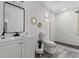 Bright bathroom featuring modern finishes, including white vanity and a glass shower at 4112 E Ellicott St, Tampa, FL 33610