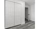 This bedroom features wood-look flooring, a closet, and white walls at 4112 E Ellicott St, Tampa, FL 33610