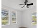 This bright room has a ceiling fan, three windows and luxury vinyl plank floors at 4112 E Ellicott St, Tampa, FL 33610