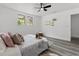 This bedroom has a ceiling fan, two windows and modern wood-look floors at 4112 E Ellicott St, Tampa, FL 33610